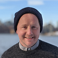 smiling man in a knit cap facing forward